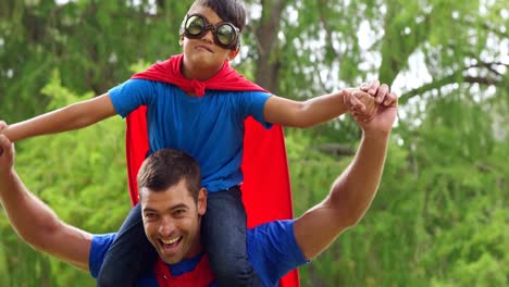 father giving piggy back to son