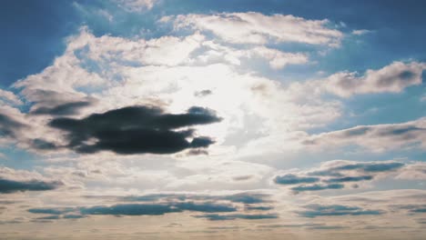 still shot of white and black clouds moving in blue sky, aerial shot