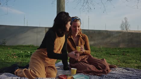 Two women having a picnic outdoors