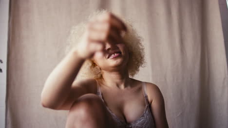 studio portrait shot of confident natural albino woman in underwear promoting body positivity