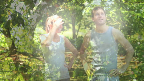 animation of happy caucasian couple running in park over leaves