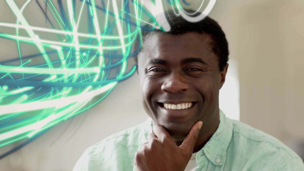 Man in soft home, shifting smile-to-laugh as teal-white trails entering-left then receding for ads