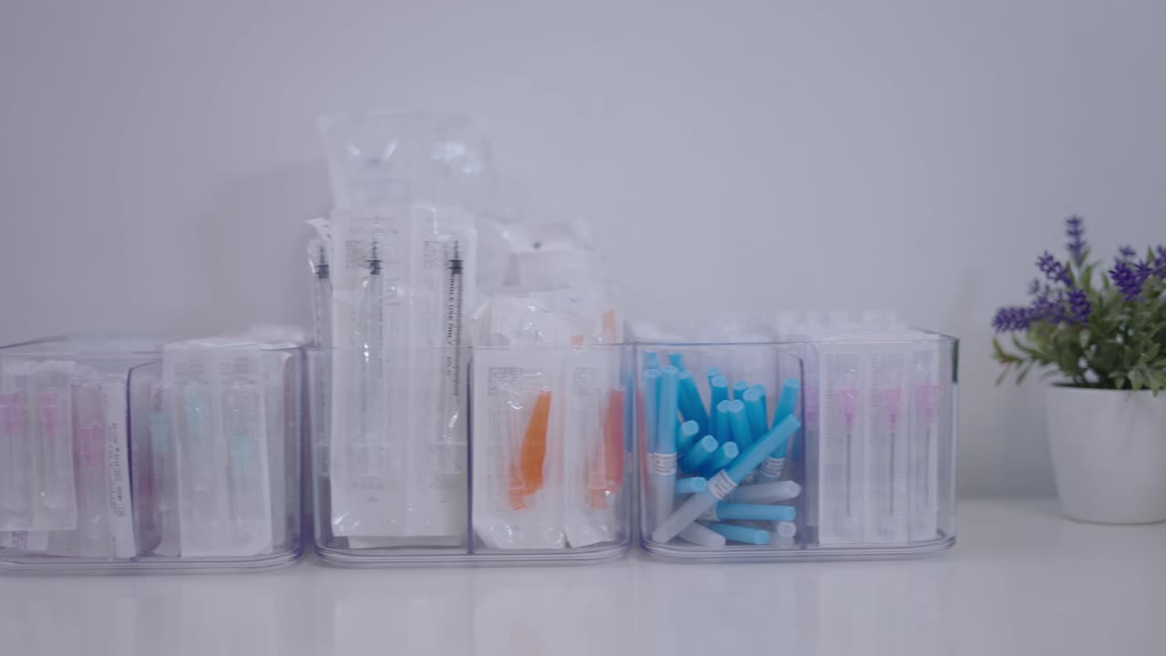 Organized Medical Syringes and Needles in Clear Storage Bins
