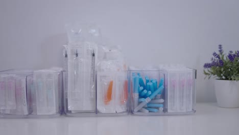 organized medical syringes and needles in clear storage bins
