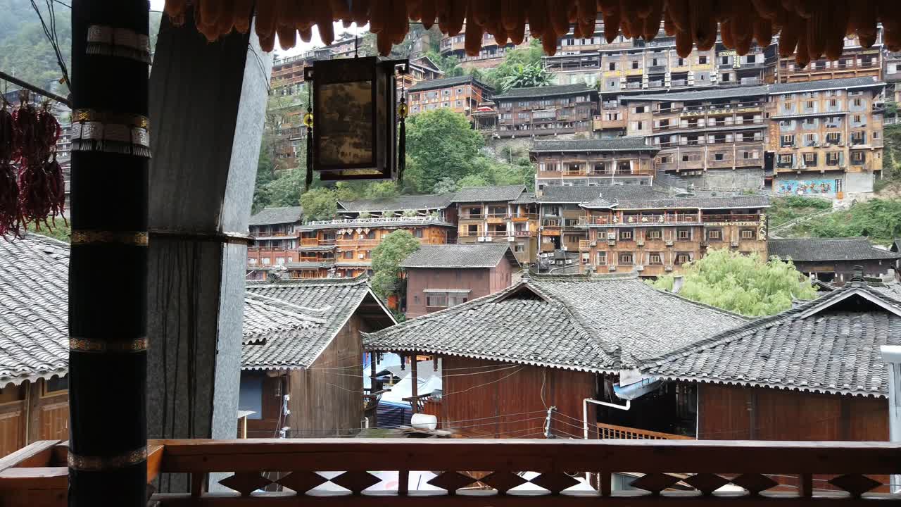Panning of Traditional terraced wooden village house, hanging dried chili and corn, Guizhou, China