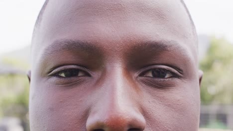 close up video portrait of eyes of african american man smiling outdoors