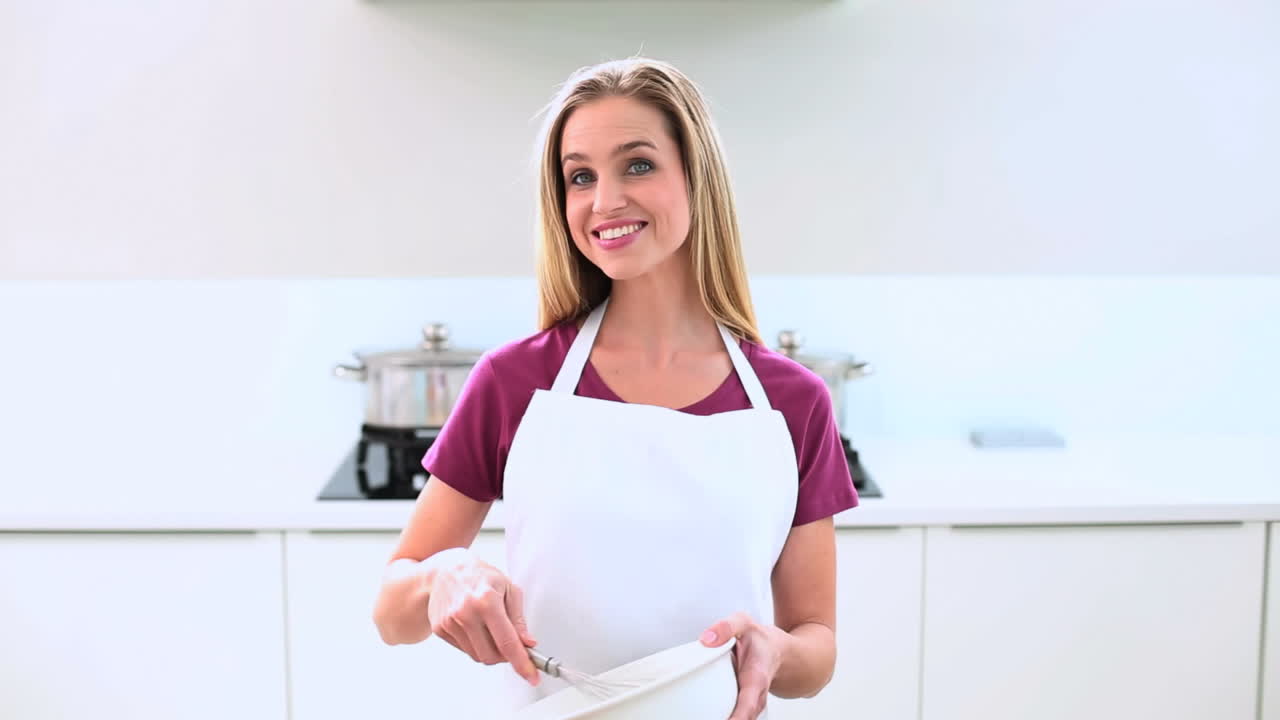 Mulher loira preparando bolo na cozinha