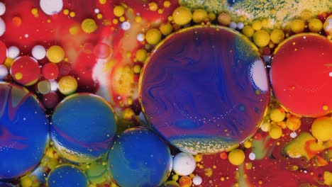 red, blue and yellow-golden bubbles on a red background.