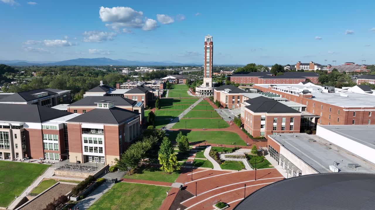 Modern brick student apartments and residential commons at liberty university. Sunny summer day in Lynchburg, Virginia. Freedom tower in background. Aerial wide shot