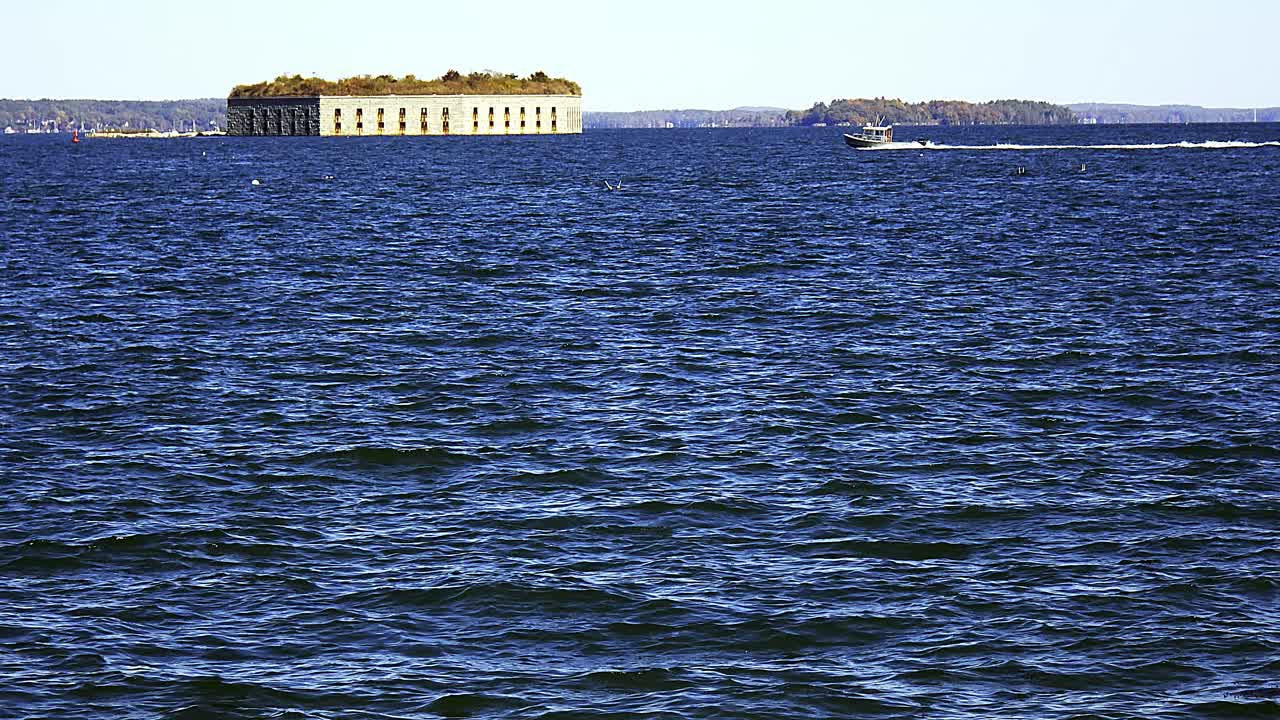 Historical Fort Gorges and sailboat in Casco Bay near Portland, Maine