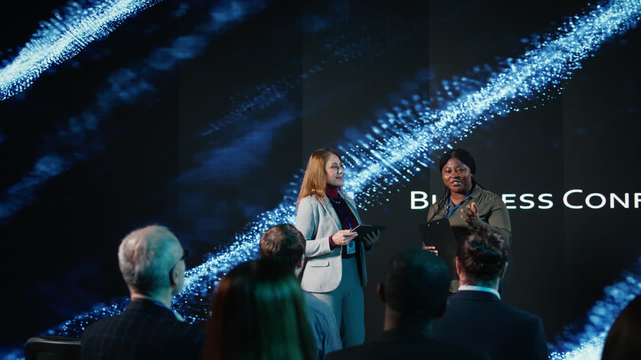 Multiethnic female adults hosting a panel discussion with market share trends