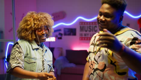 happy african american couple dancing in recording studio