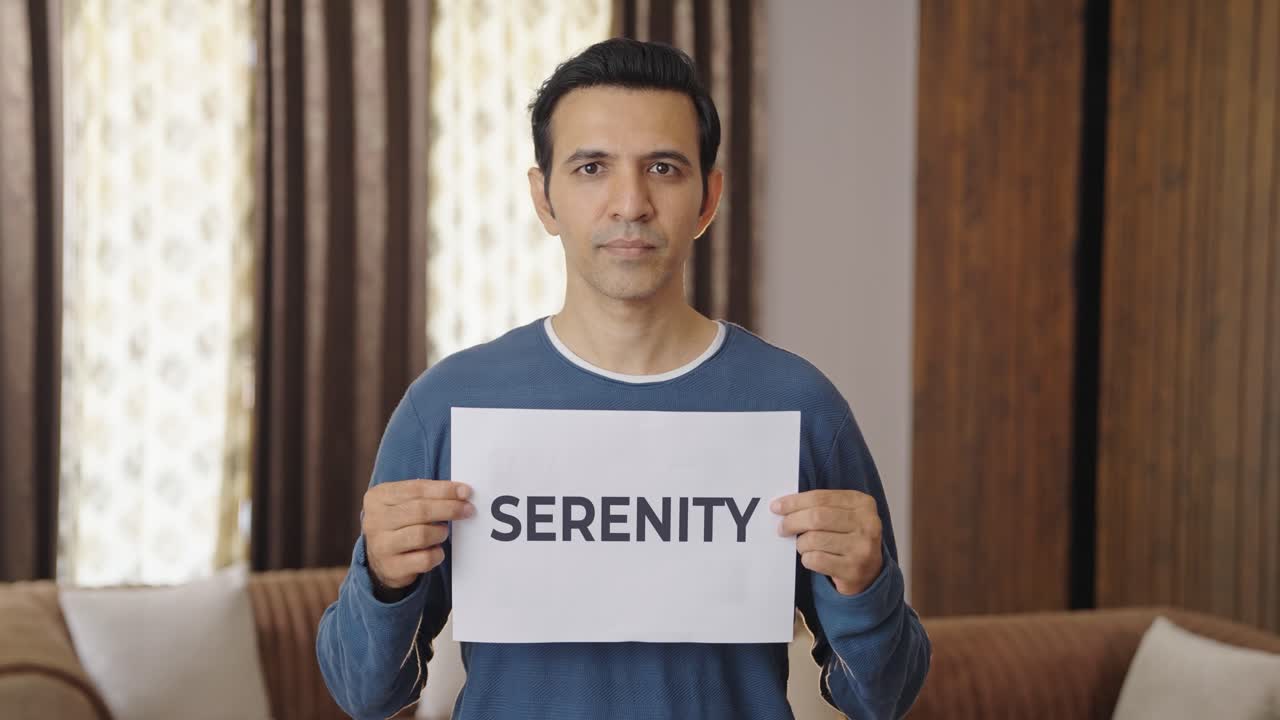 Indian man holding SERENITY banner