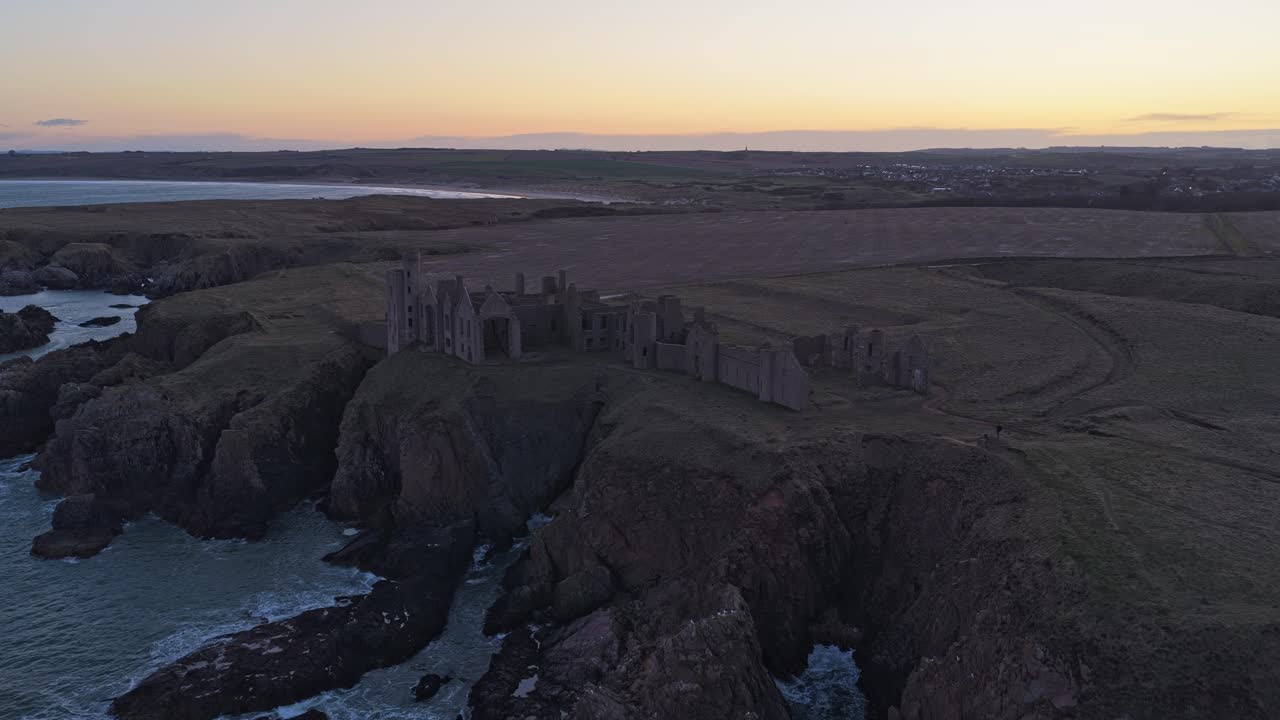 Slains castle ruins on the scottish cliffs at sunset