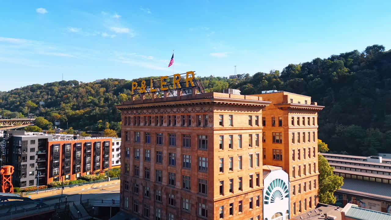 Approaching the building of the former railway station in Pittsburg, Pennsylvania, USA. Beautiful architectural memorial in the historical Station Square with an American flag on the top
