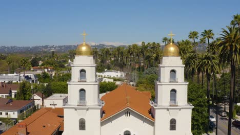 church with golden domes and palm trees