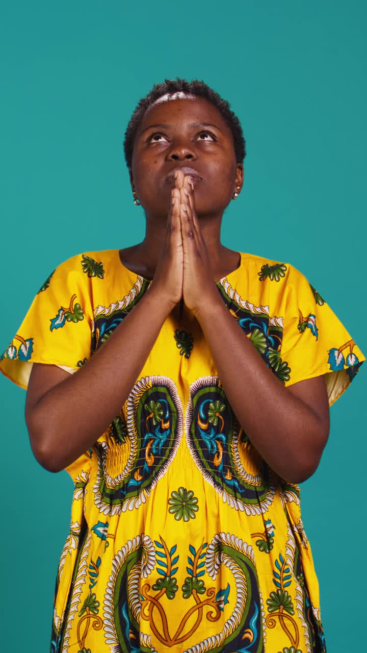Devout African Woman Praying with Hands Clasped