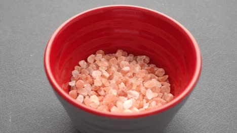 pink salt in a red bowl