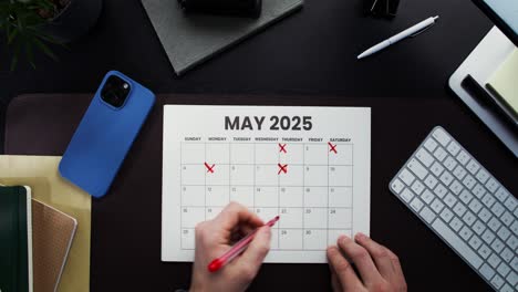 marking appointments on a may 2025 calendar