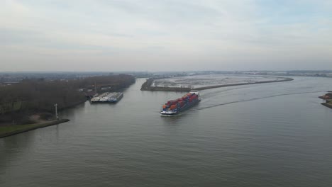 Cargo-ship-with-a-large-load-sailing-on-a-calm-river-en-route-to-New-Hampshire