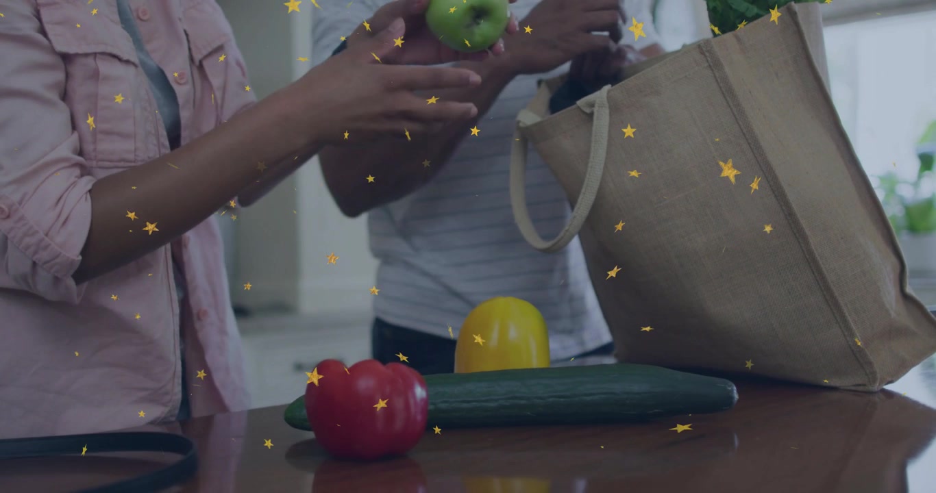 Couple reaching into grocery tote, unpacking produce on countertop prepping meal with star overlay