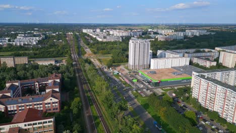 Smooth-aerial-top-view-flight-Large-panel-system-building-Apartment,-prefabricated-housing-complex,-Berlin-Marzahn-East-German-summer-2023