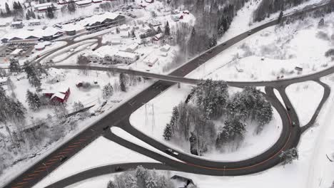 curved roads and narrow highway in snowy norway winter - aerial shot