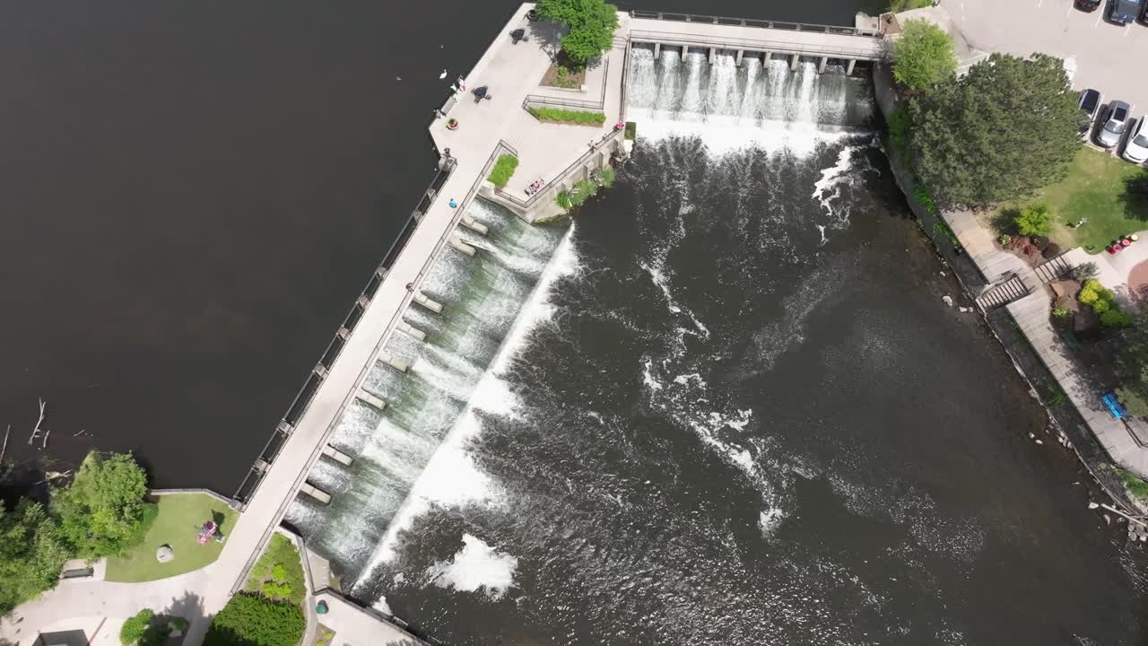 Dam on Rogue River in Rockford, Michigan with drone video overhead stable
