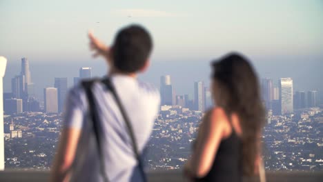 man gesturing at la skyline