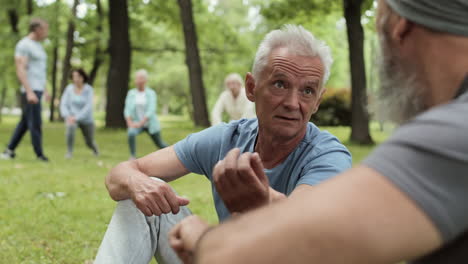 elderly men talking in a park