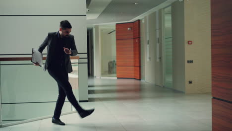businessman with documents in office hallway