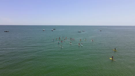 aerial view of standup paddle boarding race on waters of rexhame beach, marshfield