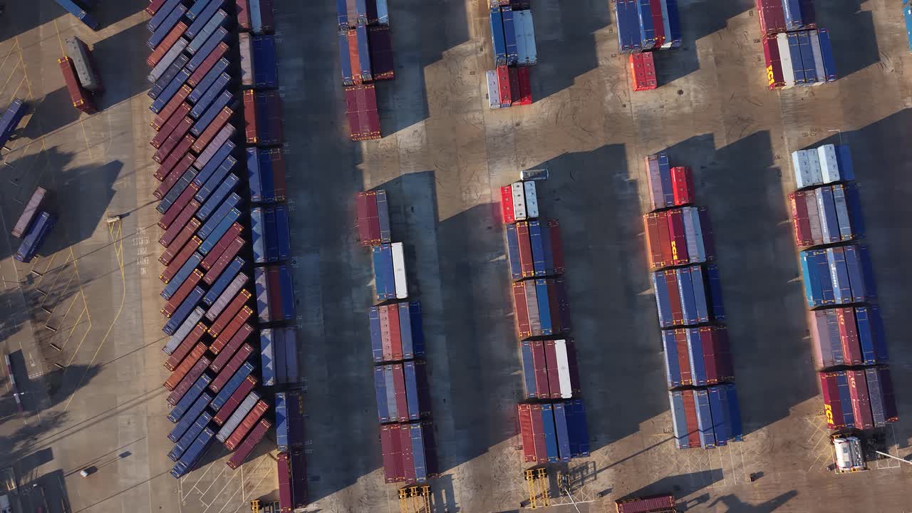Aerial circling view looking down above rows of shipping containers at Tilbury 2 storage facility