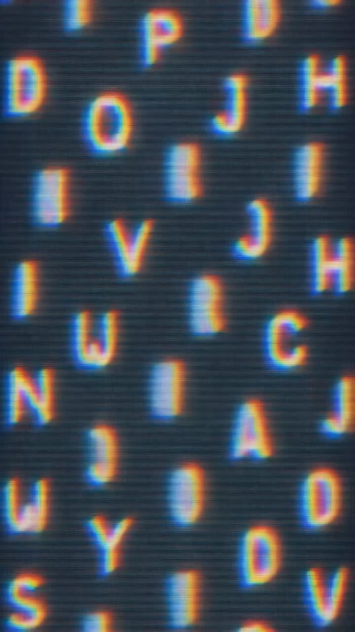 Abstract video art with a close-up angle of blurred, colorful letters on a screen