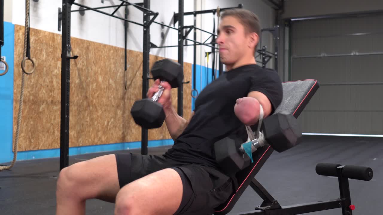 Man working out with dumbbells in the gym