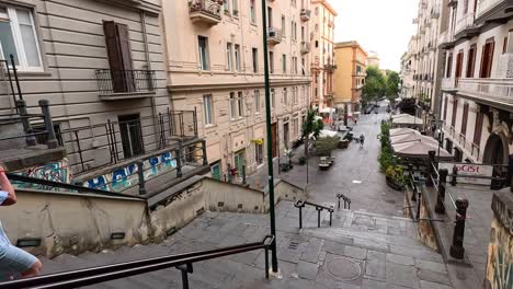 people descending stairs in a naples street