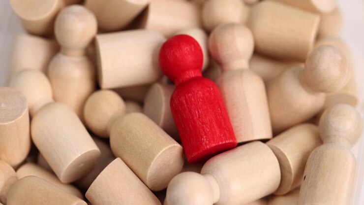 Wooden figures representing leadership and individuality