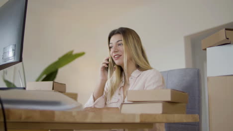 young online shop assistant consulting client on phone