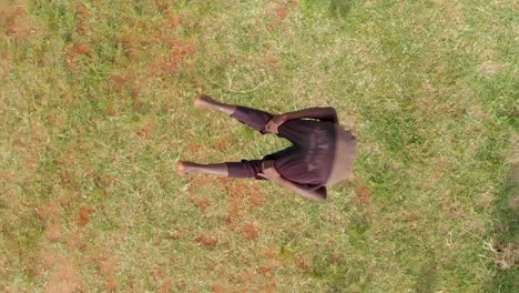 Una-Toma-A-Cámara-Lenta-A-Vista-De-Pájaro-De-Una-Joven-Bailarina-Africana-Saltando-Al-Aire