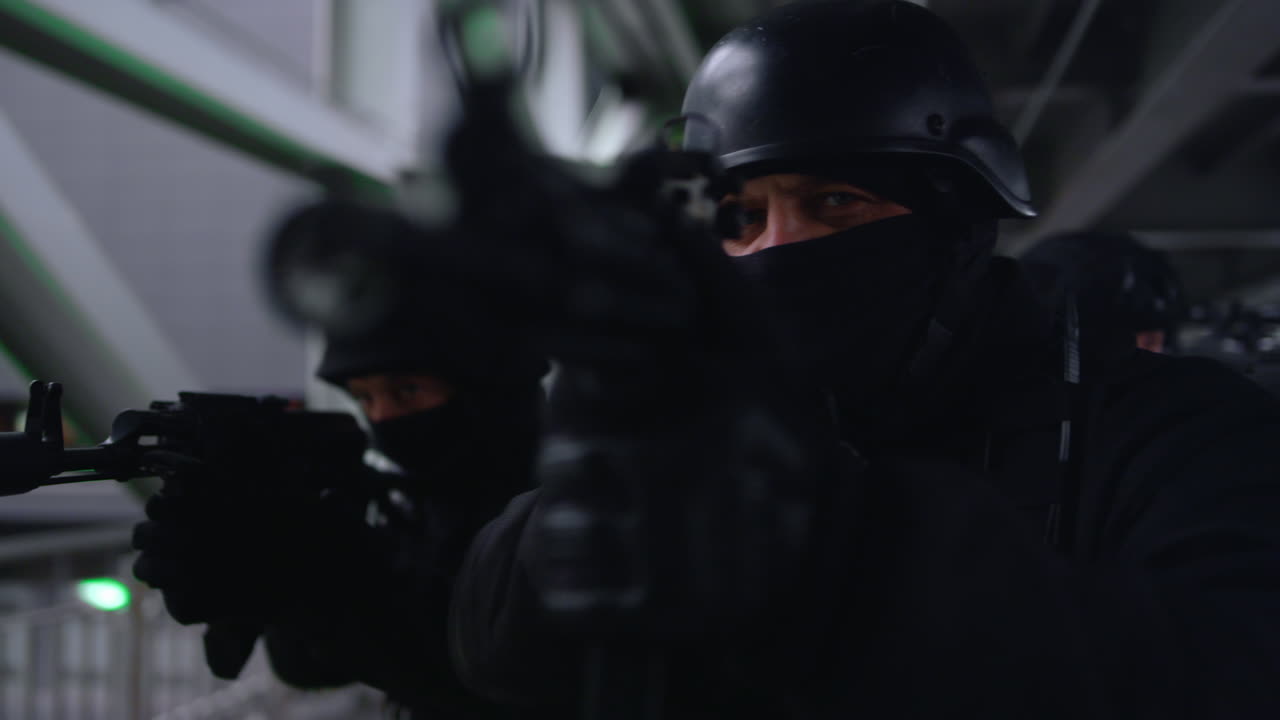 SWAT team taking aim on rifles