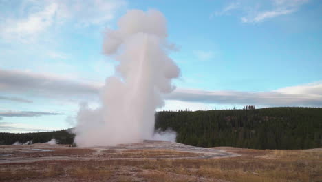 cinematic famous old faithful geyser sunrise sunset eruption yellowstone national park observation deck viewing area upper geyser basin active volcano fall autumn october pink orange slow motion