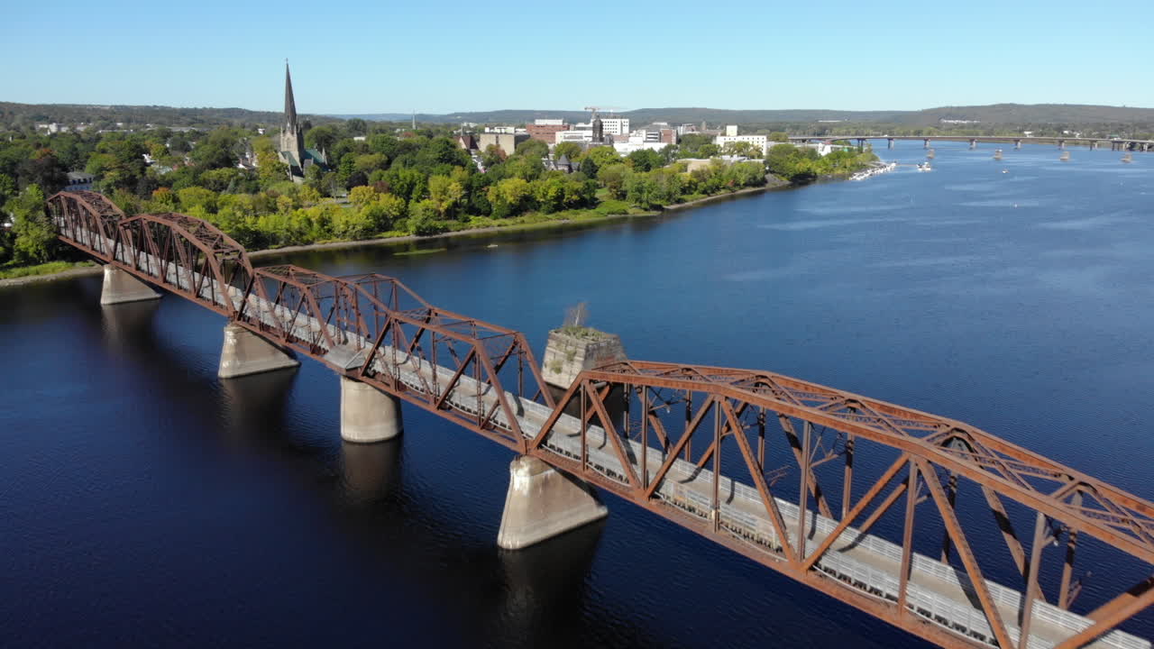 AERIAL: Flying Past Walking Bridge On Saint John River in Fredericton, New Brunswick
