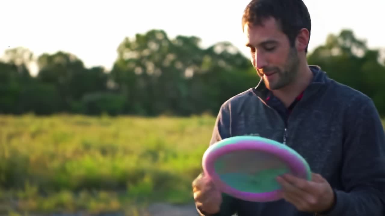 A Joyful Moment of Play: A Man Engaging with His Dog Outdoors, Equipped with a Colorful Frisbee Against a Lush Green Backdrop