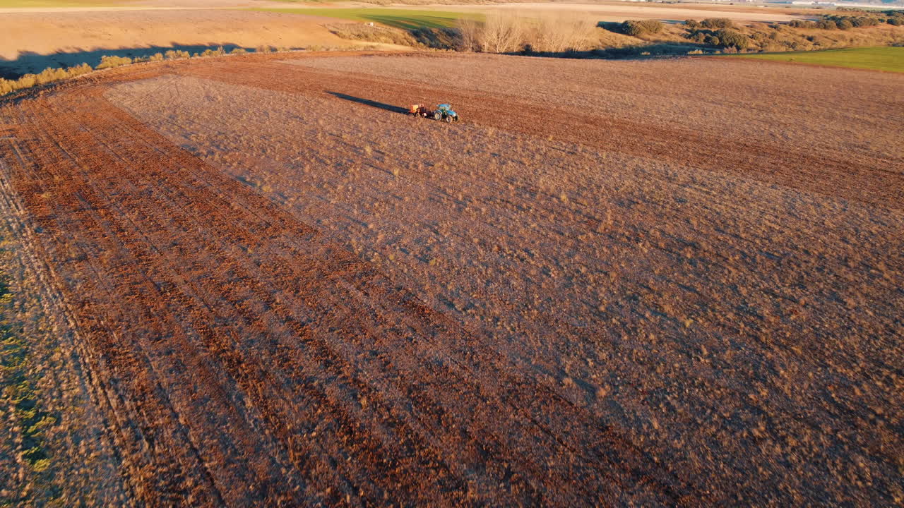 Aerial view of a tractor plowing a field