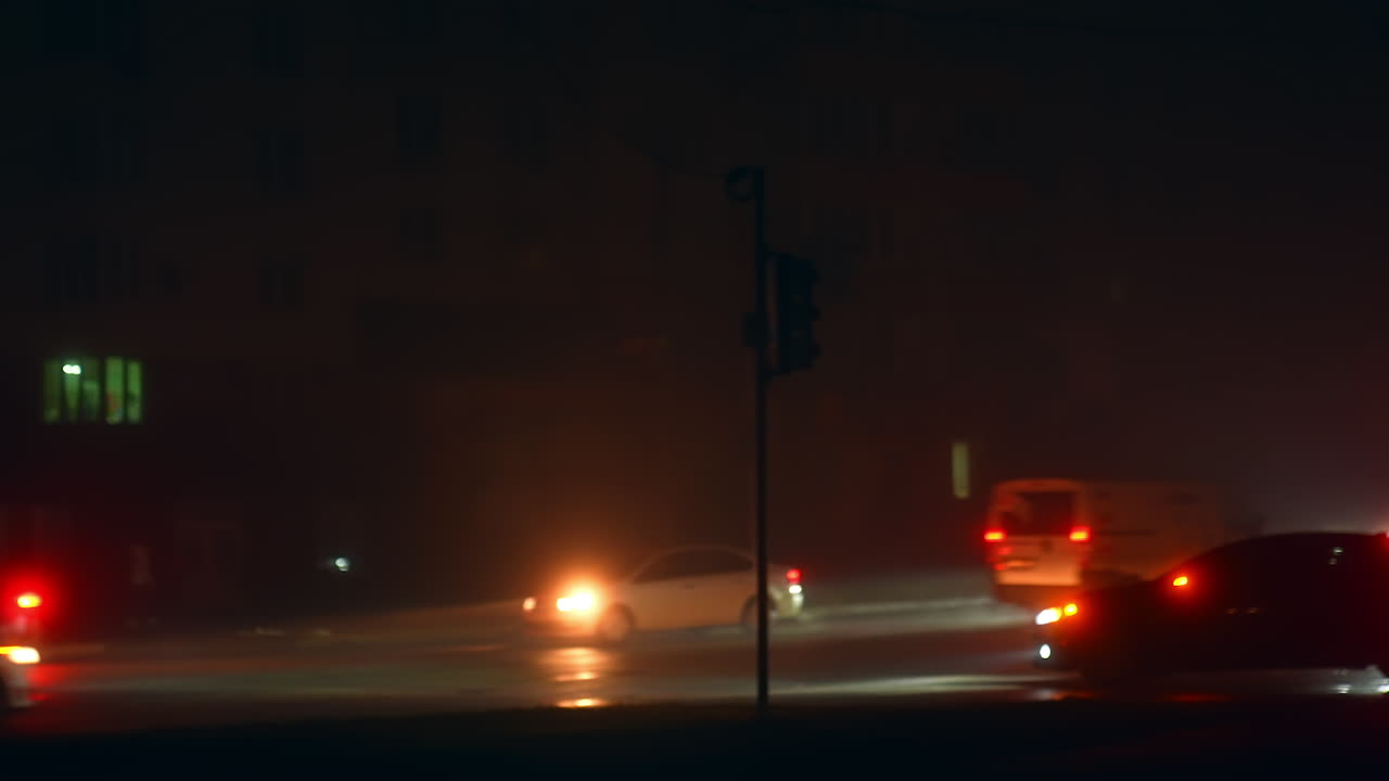 Night Traffic in Foggy City Intersection