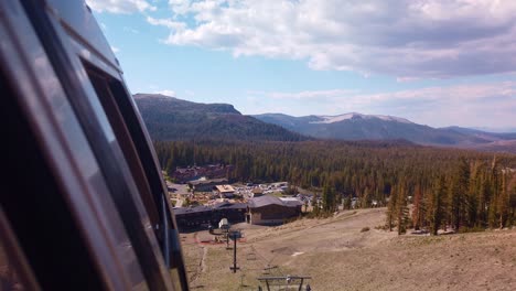 gimbal shot from gondola as it approaches the mammoth mountain ski lodge in california during the summer