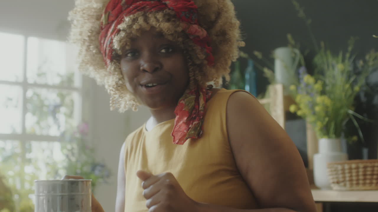 Woman Singing and Dancing while Cooking Food