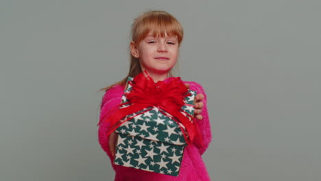 lovely smiling preteen child girl kid presenting birthday gift box offer wrapped present celebrating