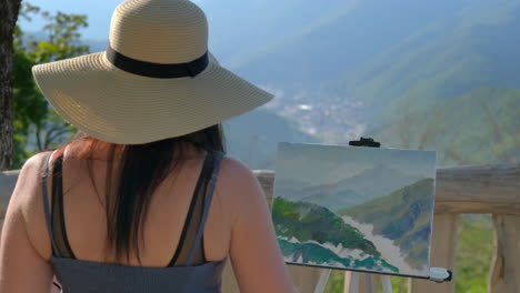 artist painting a mountain landscape