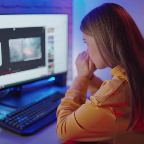 . teenager watching video at home. young woman looking at computer at home